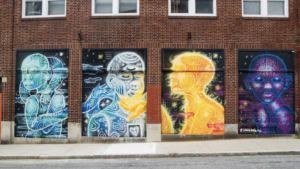 Four panel mural of figures interacting on a large wall. Sun, moon, universe and earth as embodied beings. Art, mural, caring, love, interconnectivity, connection. joy, dialogue, inclusion, The Avenue Concept